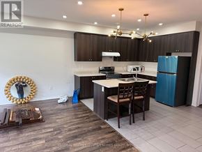 Niagara Falls (Brown) apartment for rent - A kitchen with a white counter top and brown cabinets.