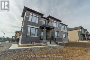 Thorold (Hurricane/Merrittville) apartment for rent - A modern two-story house with a grey exterior and a black metal railing on the balcony.