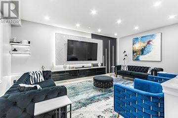 Hamilton (Binbrook) apartment for rent - A living room with a black couch and a blue chair.