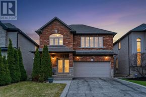 Hamilton (Binbrook) apartment for rent - A house with a garage and a driveway in front of it.