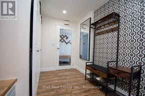 Asphodel-Norwood apartment for rent - A hallway with a bench and a mirrored door.