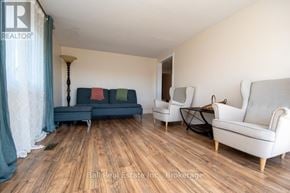 Asphodel-Norwood apartment for rent - A living room with a couch, armchairs, and a lamp.