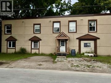Chatham apartment for rent - A beige building with a blue barrel in front of it.
