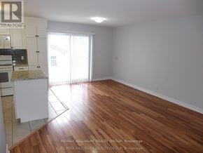 Ottawa triplex for rent - A room with wooden flooring and white walls.