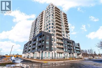 Kitchener condo for rent - A tall residential building with a clear sky in the background.