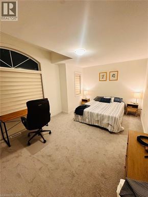 Paris apartment for rent - A bedroom with a bed, chair, and two lamps.
