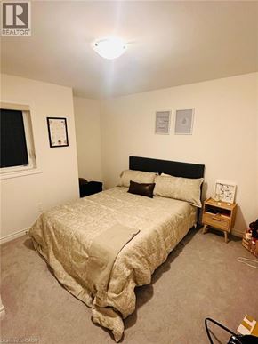 Paris apartment for rent - A bedroom with a bed, nightstand, and two pictures on the wall.