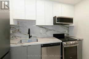 Toronto (Mount Pleasant West) condo for rent - A kitchen with a marble backsplash and white cabinets.