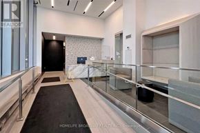 Toronto (Mount Pleasant West) condo for rent - A hallway with a black carpet and glass railings.