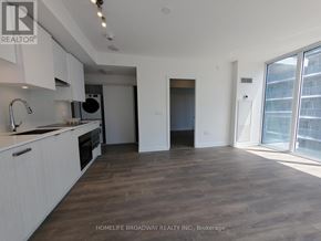 Toronto (Mount Pleasant West) condo for rent - A spacious kitchen with white cabinets and a wooden floor.