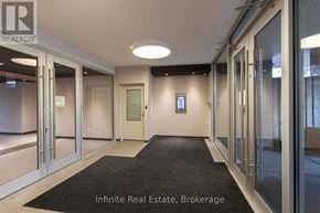 Toronto (University) condo for rent - A hallway with a sign that says Infinite Real Estate Brokerage.