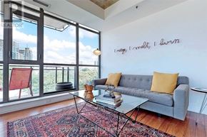 Toronto (Moss Park) condo for rent - A living room with a grey couch and a glass table.