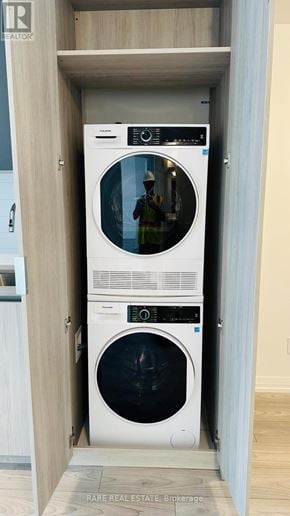 Toronto (Waterfront Communities) condo for rent - A white washing machine and dryer in a cabinet.