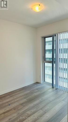 Toronto (Waterfront Communities) condo for rent - A room with a sliding glass door leading to a balcony.