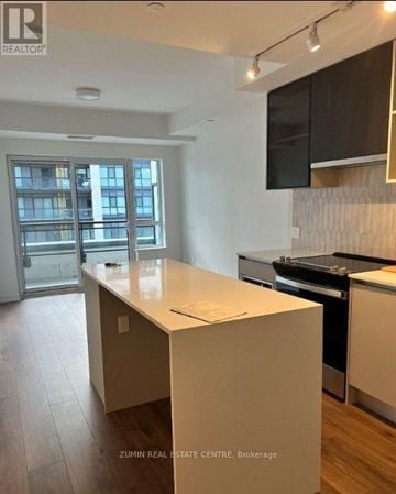 Oakville (Nw Northwest) condo for rent - A kitchen with a white countertop and a stove top oven.