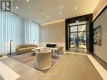 Hamilton (Beasley) condo for rent - A modern living room with a fireplace and a large painting on the wall.