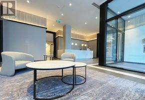 Hamilton (Beasley) condo for rent - A modern office space with a glass wall and a white table in the center.