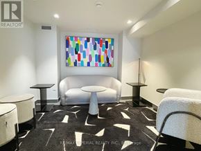 Hamilton (Beasley) condo for rent - A white couch sits in a room with a colorful painting on the wall.