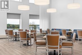 Gravenhurst (Muskoka (S)) house for rent - A room with a table and chairs and a window overlooking a body of water.