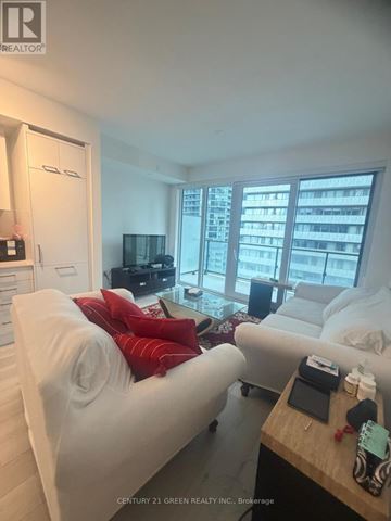 Toronto (Church-Yonge Corridor) condo for rent - A living room with a white couch and a wooden table.