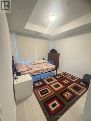 Toronto (Church-Yonge Corridor) condo for rent - A bedroom with a bed, dresser, and a rug on the floor.