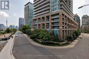 Toronto (Niagara) condo for rent - A street view of a city with apartment buildings and cars.