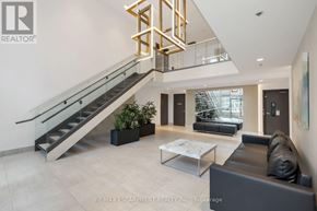 Toronto (Niagara) condo for rent - A modern living room with a staircase and a glass railing.