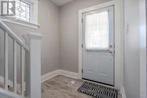 Thorold (Thorold Downtown) multi-family for rent - A white door with a window above it in a room.