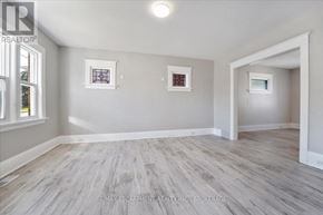 Thorold (Thorold Downtown) multi-family for rent - A room with grey walls and wooden flooring.