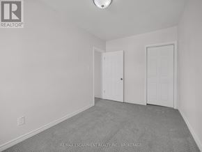 Thorold (Thorold Downtown) apartment for rent - A room with a carpeted floor and two doors.