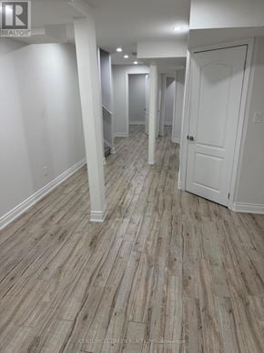 Milton (Sc Scott) apartment for rent - A hallway with wood flooring and white walls.