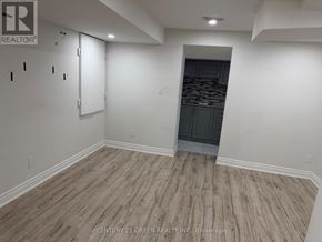 Milton (Sc Scott) apartment for rent - A room with wooden flooring and a doorway leading to another room.