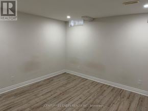 Milton (Sc Scott) apartment for rent - A room with wooden flooring and white walls.