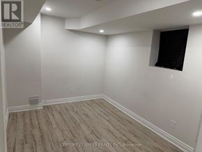 Milton (Sc Scott) apartment for rent - A room with wooden flooring and white walls, with a window on the right wall.