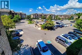 Burlington condo for rent - A parking lot with cars and a building in the background.