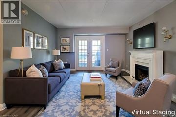 Burlington condo for rent - A living room with a blue carpet and a fireplace.