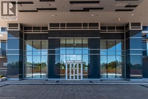 Burlington condo for rent - A modern building entrance with a glass door and a sign that reads REALTOR.