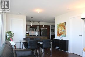 Richmond apartment for rent - A living room with a black couch and a dining table.