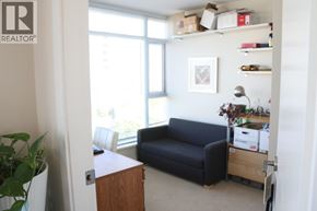 Richmond apartment for rent - A living room with a black couch and a wooden cabinet.