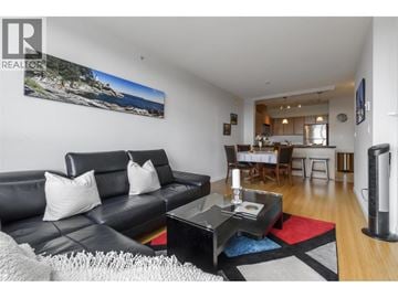 Coquitlam apartment for rent - A living room with a black couch and a coffee table.