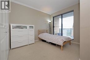 Coquitlam apartment for rent - A bedroom with a bed, dresser, and window.