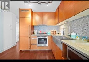 Vancouver apartment for rent - A modern kitchen with wooden cabinets and stainless steel appliances.