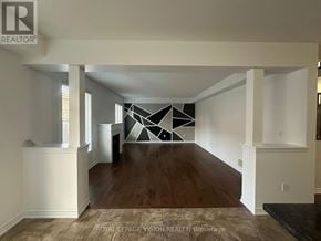 Oshawa (Samac) apartment for rent - A large, empty room with wooden floors and white walls.