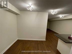 Mississauga (City Centre) condo for rent - A room with a white wall and a wooden floor.