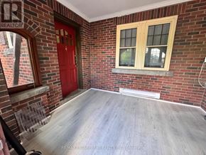 Burlington (Lasalle) apartment for rent - A room with a red door and a window with wooden frames.