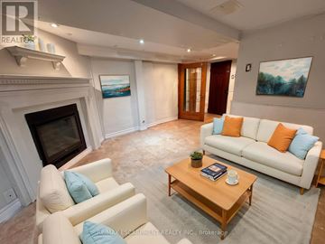 Burlington (Lasalle) apartment for rent - A living room with a fireplace and a painting on the wall.