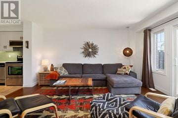 Collingwood townhouse for rent - A living room with a grey couch and a wooden coffee table.