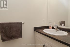 Collingwood townhouse for rent - A bathroom with a sink, mirror, and towel.