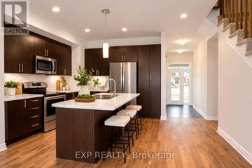 Russell townhouse for rent - A modern kitchen with dark wood cabinets and a white island.