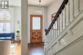 Ottawa townhouse for rent - A staircase with white railings and a wooden door.